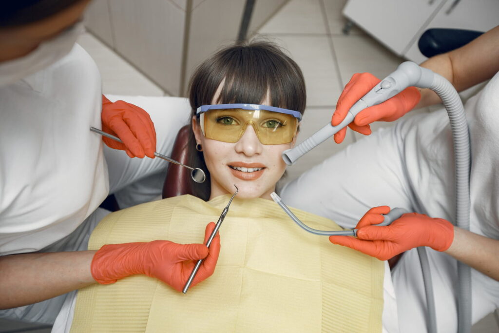 Teen girl in a dental chair during a routine exam, representing wisdom teeth checkups for Curaçao teens