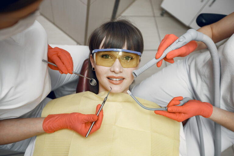 Teen girl in a dental chair during a routine exam, representing wisdom teeth checkups for Curaçao teens
